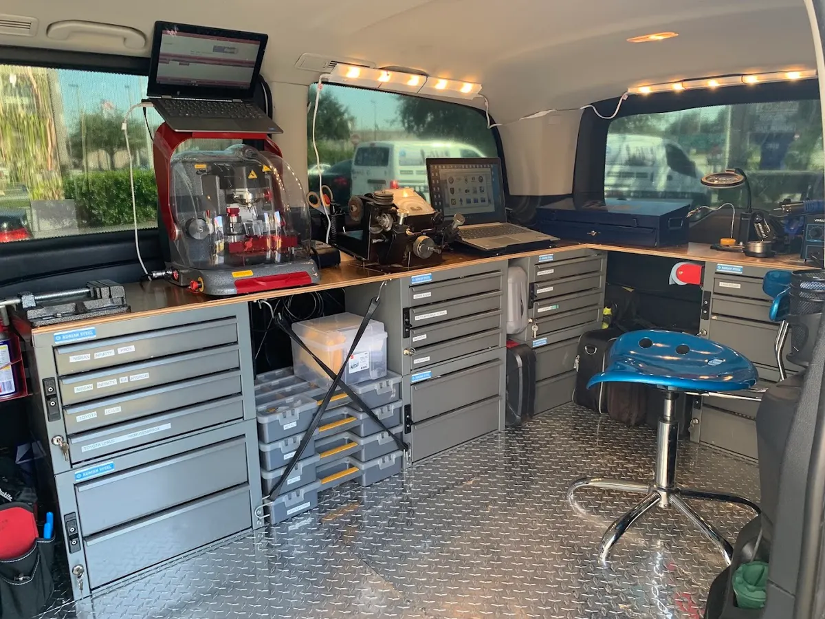 Inside one of our vans: key cutting machines, laptops and drawers of key blanks